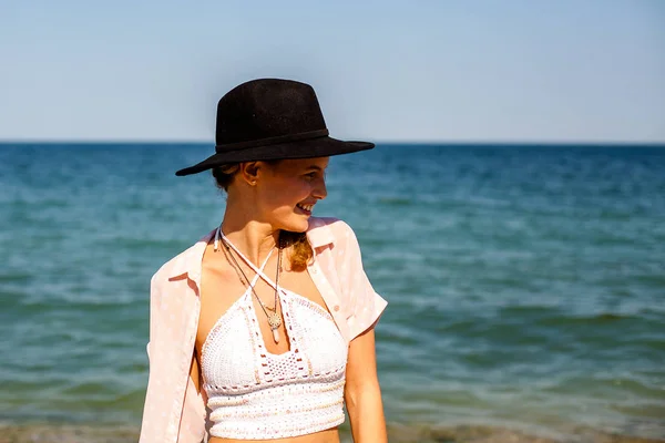 summer vibe and party girl with hat, at a summer party on a beach with cocktail having fun