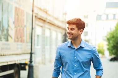Genç yakışıklı ve kendine güvenen adam akıllı gündelik kıyafeti, office gün, sokakta ayakta dışında ve yan için arıyorsunuz