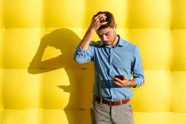 Problemi Elegante Ragazzo Intelligente Con Cellulare Piedi Uno Sfondo Giallo — Foto Stock