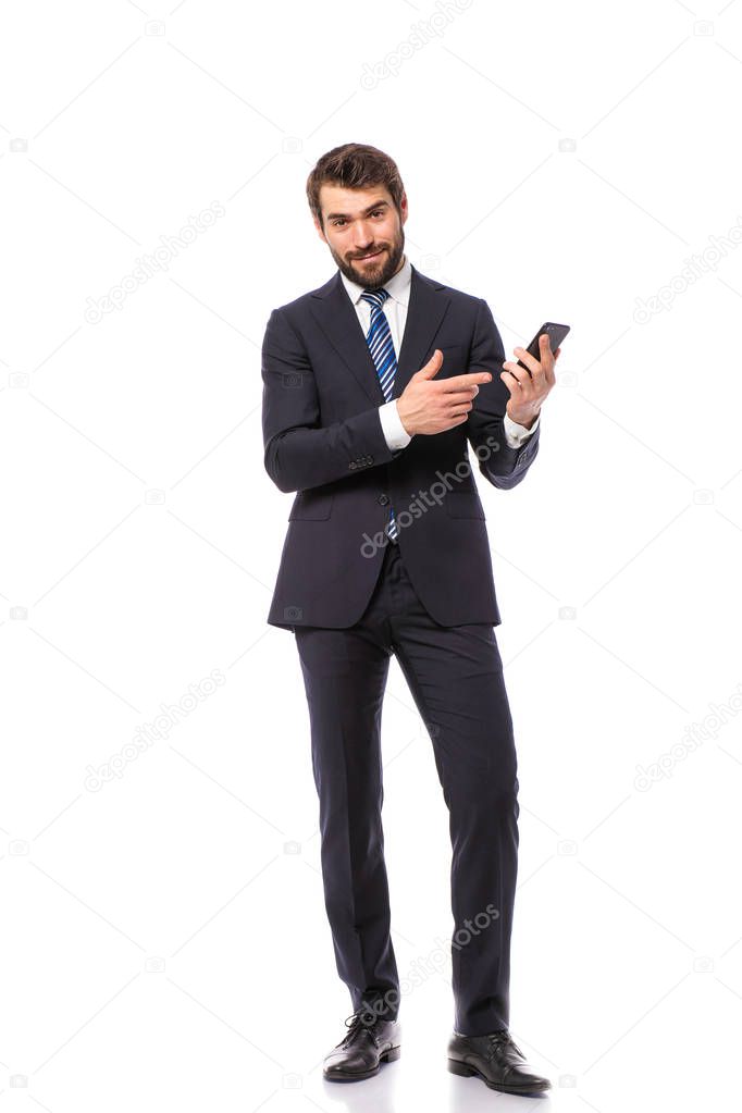 corporate man, elegant businessman standing on white background holding his cellphone and pointing on of the empty sides