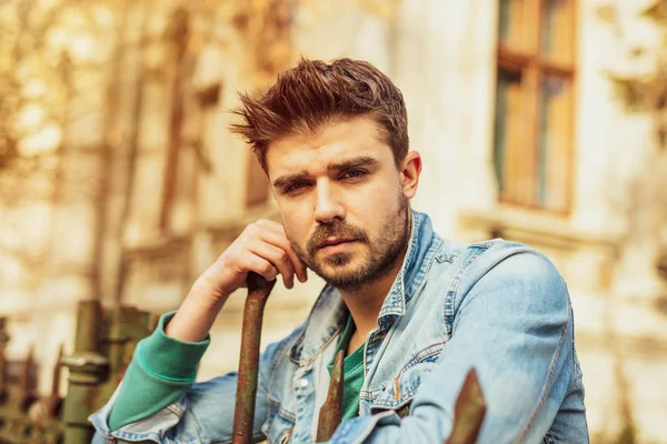 Handsome Guy Jeans Jacket Standing Metal Fence — Stock Photo, Image