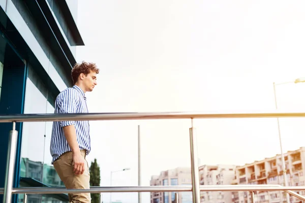 smart men standing in front of a building outside