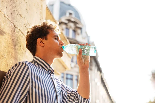 Young man drinking water outside — Stock Photo, Image
