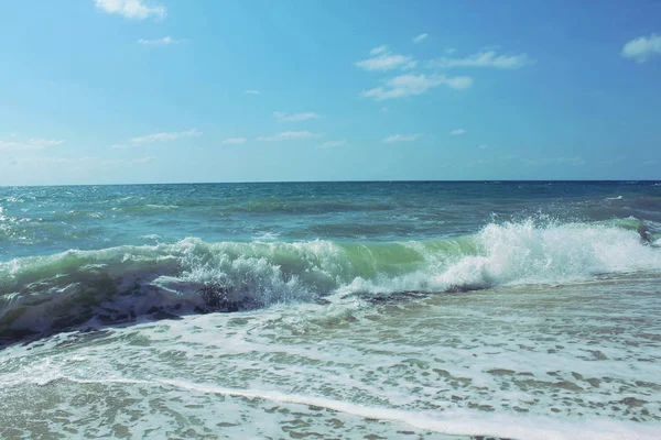 Raging waves roll on the beach