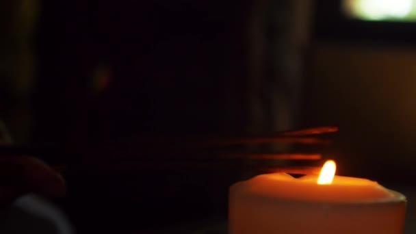 Close Candle Flame Which People Ignites Incense Sticks Only Hands — Stock Video