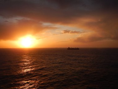 Şaşırtıcı günbatımı okyanus ve kargo gemisi onun hedef bağlantı noktasına gezinme.