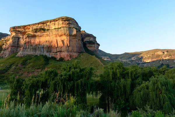 Scenic panoramic  color landscape picture taken in South Africa Drakensberg Golden Gate national park landscape on a sunny day - impressive nature with rock landmark, blue sky,tress