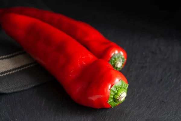 Close Two Red Peppers Slate Stone Background Dishcloth — Stock Photo, Image