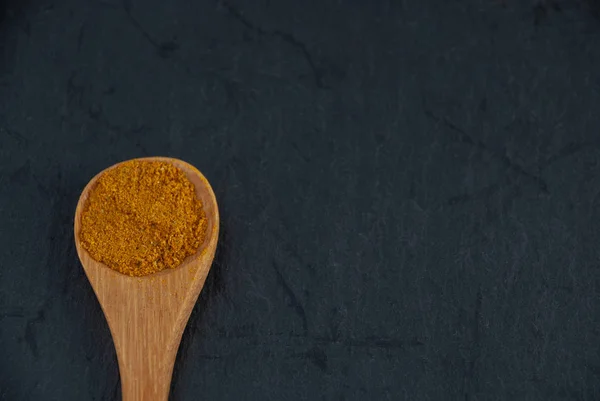 Primo Piano Cucchiaio Legno Con Curry Sfondo Nero Pietra Ardesia — Foto Stock