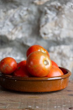 Dikey ahşap masada kil kase bahçe domates üst görünümü