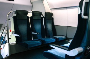 Tren koltukları mavi. Modern ve rahat bir trende boş koltuklar. Seyahat ve iş seyahatleri için uygun bir yolcu taşımacılığı. Ulaşım, lojistik ve trafik kavramı.