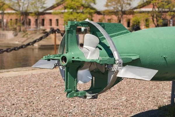 The tail of the torpedo with rudders and propellers mounted on the pier as an exhibit of a museum of weapons.