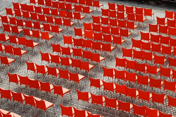 Empty Outdoor Theater with lot of Red Chairs in Rows