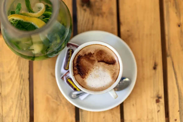 Shot from Above of Cup of Coffee and Green Tea on Wooden Table in Cafe