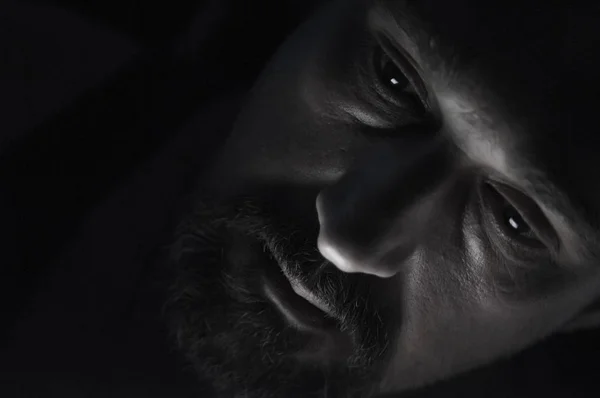 Depressed Man with Beard in Dark Room. Problems, Anxiety, Sadness Concept.