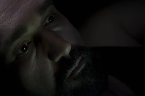 Depressed Man with Beard in Dark Room. Problems, Anxiety, Sadness Concept.