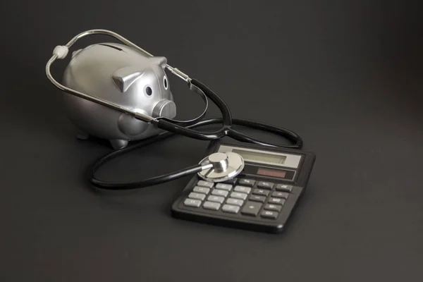 Healthcare costs, piggy bank and stethoscope