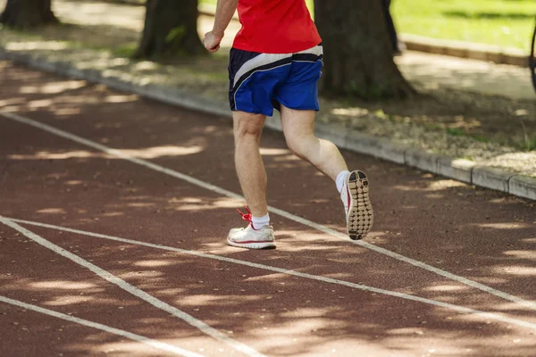 Athlete on track with running shoes