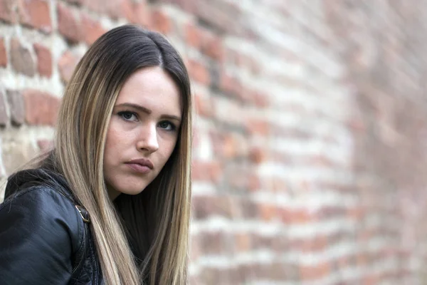 Portrait stressed sad young woman standing outdoors. City life style stress.