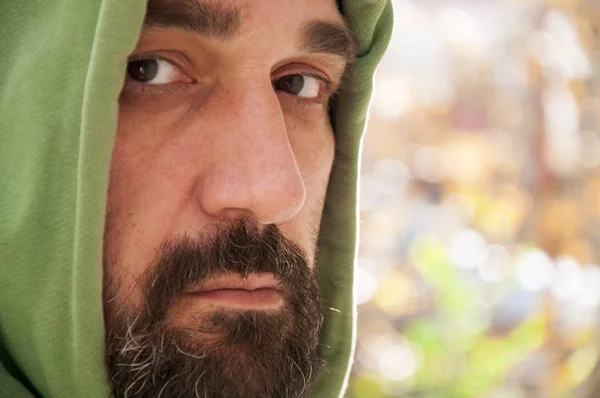 Serious portrait of adult man with hoodie