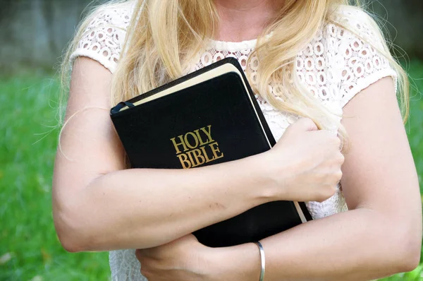 beautiful woman Holding Bible book