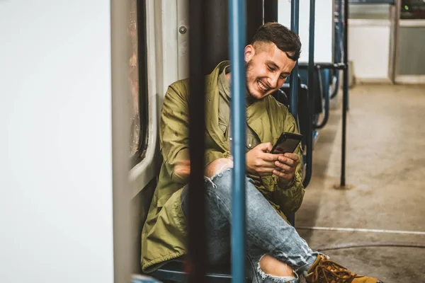 People, lifestyle, travel and public transport. Attractive man looking at the phone while sitting in public bus.