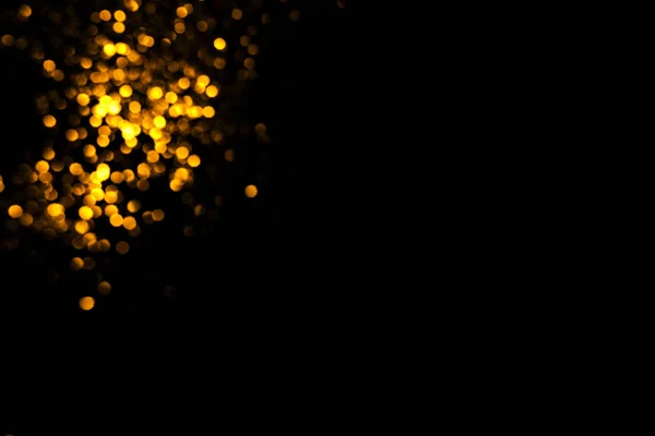Golden abstract bokeh on black background. — Stock Photo, Image