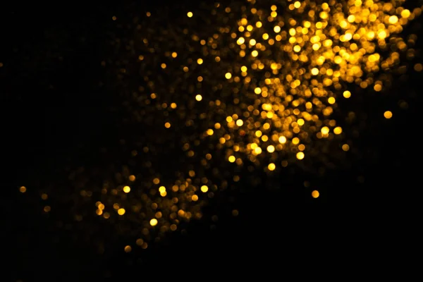 Siyah arkaplanda altın soyut bokeh.