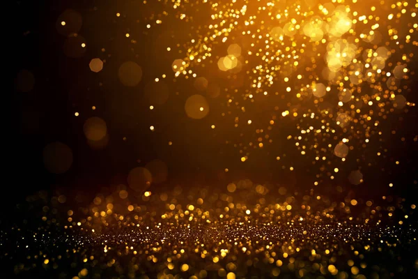 Gouden abstracte bokeh op zwarte achtergrond. — Stockfoto