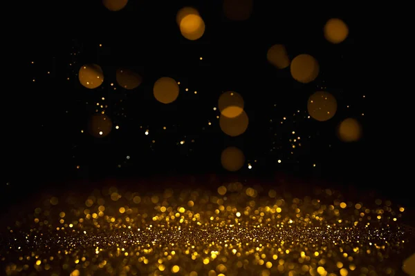 Siyah arkaplanda altın soyut bokeh.