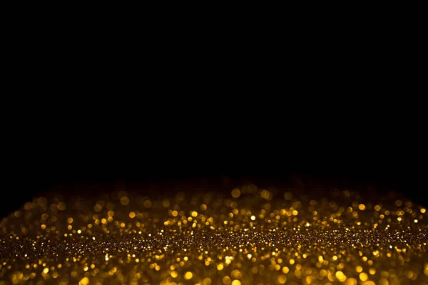 Bokeh abstrato dourado no fundo preto. — Fotografia de Stock