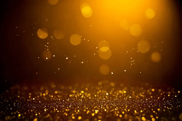 Goldenes abstraktes Bokeh auf schwarzem Hintergrund. — Stockfoto