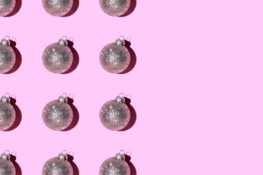 Pembe arka planda gümüş toplarından yapılmış desen.