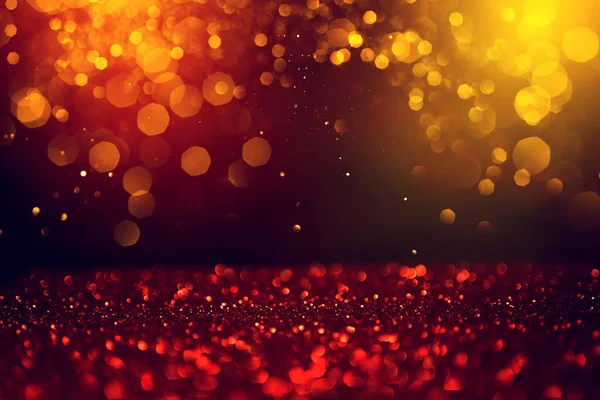 Golden abstrakt bokeh på svart bakgrund. — Stockfoto