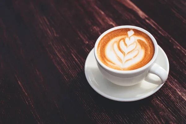 Copa de capuchino sobre mesa de madera . — Foto de Stock