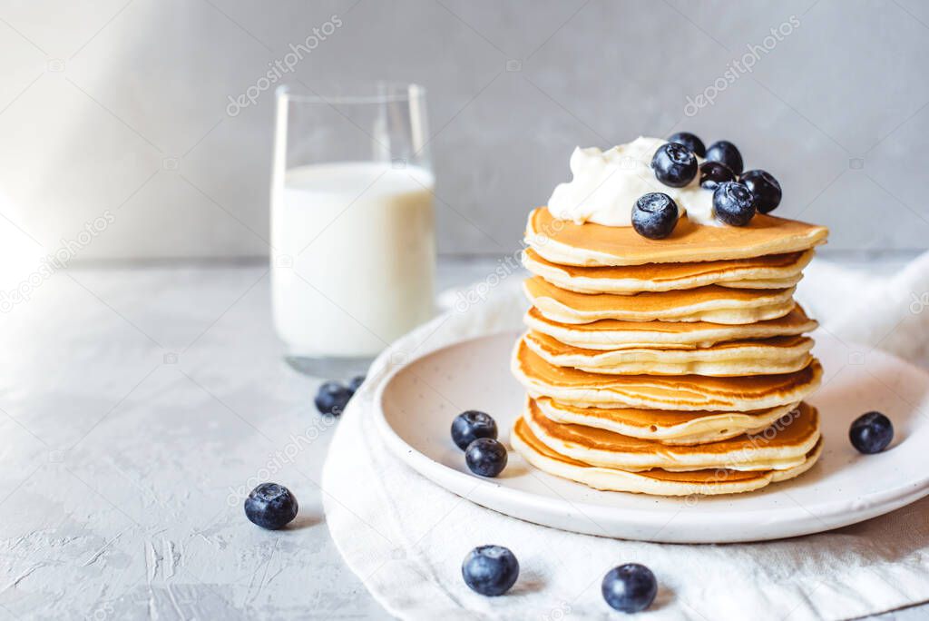 Stack of pancakes with fresh blueberry.