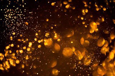 Siyah arkaplanda altın soyut bokeh.