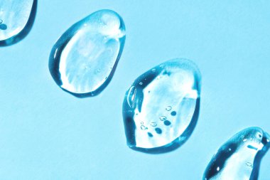 Transparent hyaluronic acid gel on a blue background. clipart