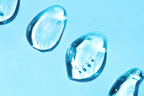 Transparent hyaluronsyra gel på en blå bakgrund. — Stockfoto