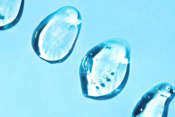 Transparent hyaluronic acid gel on a blue background. — Stock Photo, Image