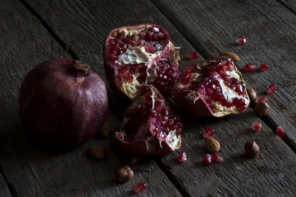 Close Whole Pomegranate Crushed Pomegranate Background Old Wooden Table — Stock Photo, Image