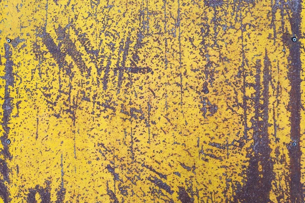 Worn yellow paint on metal sheet texture