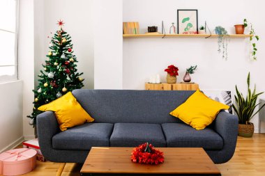 Decorated christmas tree adding a touch of magic to a cozy living room, creating a warm and inviting atmosphere for the holiday season