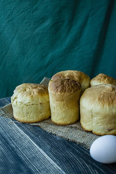 Bolo de Páscoa em um fundo escuro. Bolos frescos com frutas secas. O processo de cozinhar bolo de Páscoa. Vista do lado . — Fotografia de Stock