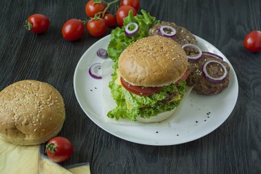 Beyaz tabakta taze ev yapımı burger. Yemek burger için malzemeler. Sağlıksız gıda.