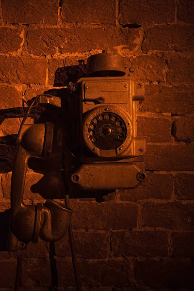 Old landline phone. Phone on a brick wall.