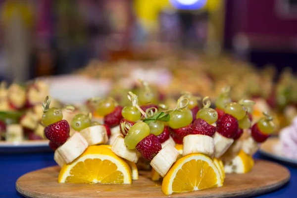 sweet buffet table. Beautifully decorated catering banquet table with burgers, profiteroles, salads and cold snacks. Variety of tasty delicious snacks on the table