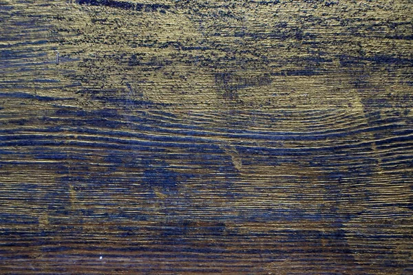 Wood texture treated with ebony stain and gold paint. Surface treatment of antique wood. Wood texture treated with ebony stain and gold paint.