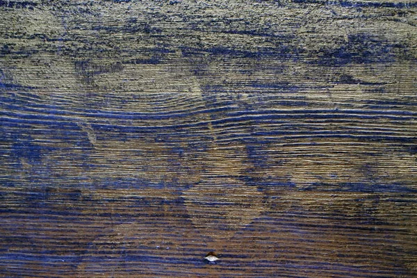 Wood texture treated with ebony stain and gold paint. Surface treatment of antique wood. Wood texture treated with ebony stain and gold paint.