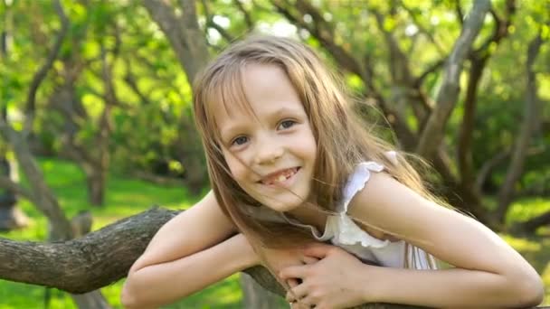 Cute girl in blooming apple tree garden enjoy the warm day — Stock Video